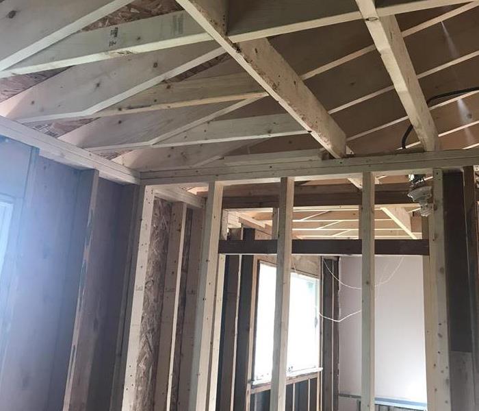 new wood framing in a bedroom after a tree hit a home