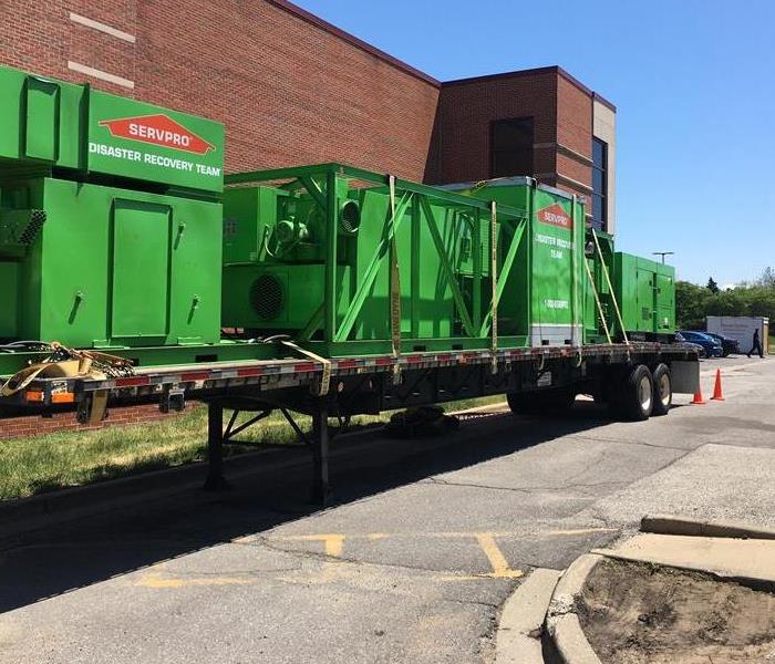 Large green drying equipment on a flatbed trailer