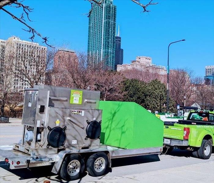 SERVPRO green vehicle and equipment in front of a building in downtown Chicago